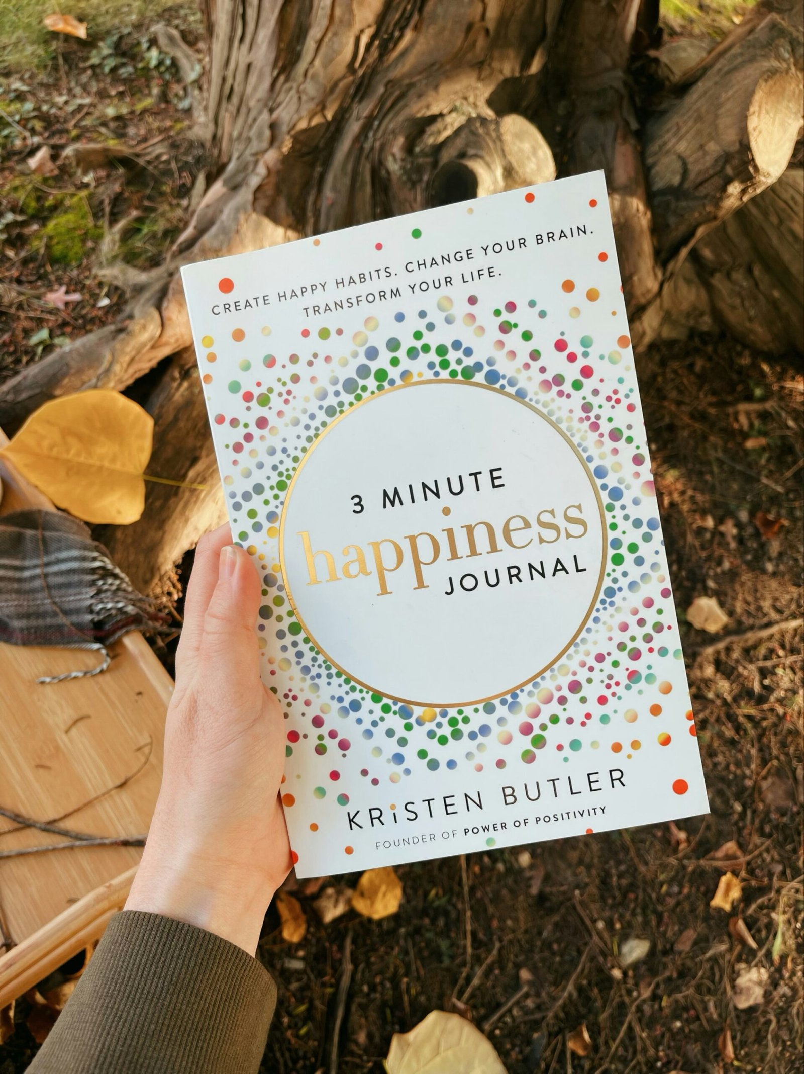 If You Want to Live a Happier Life at 60 and Beyond, Start Saying Goodbye to These 8 Habits 1 a hand holding a book